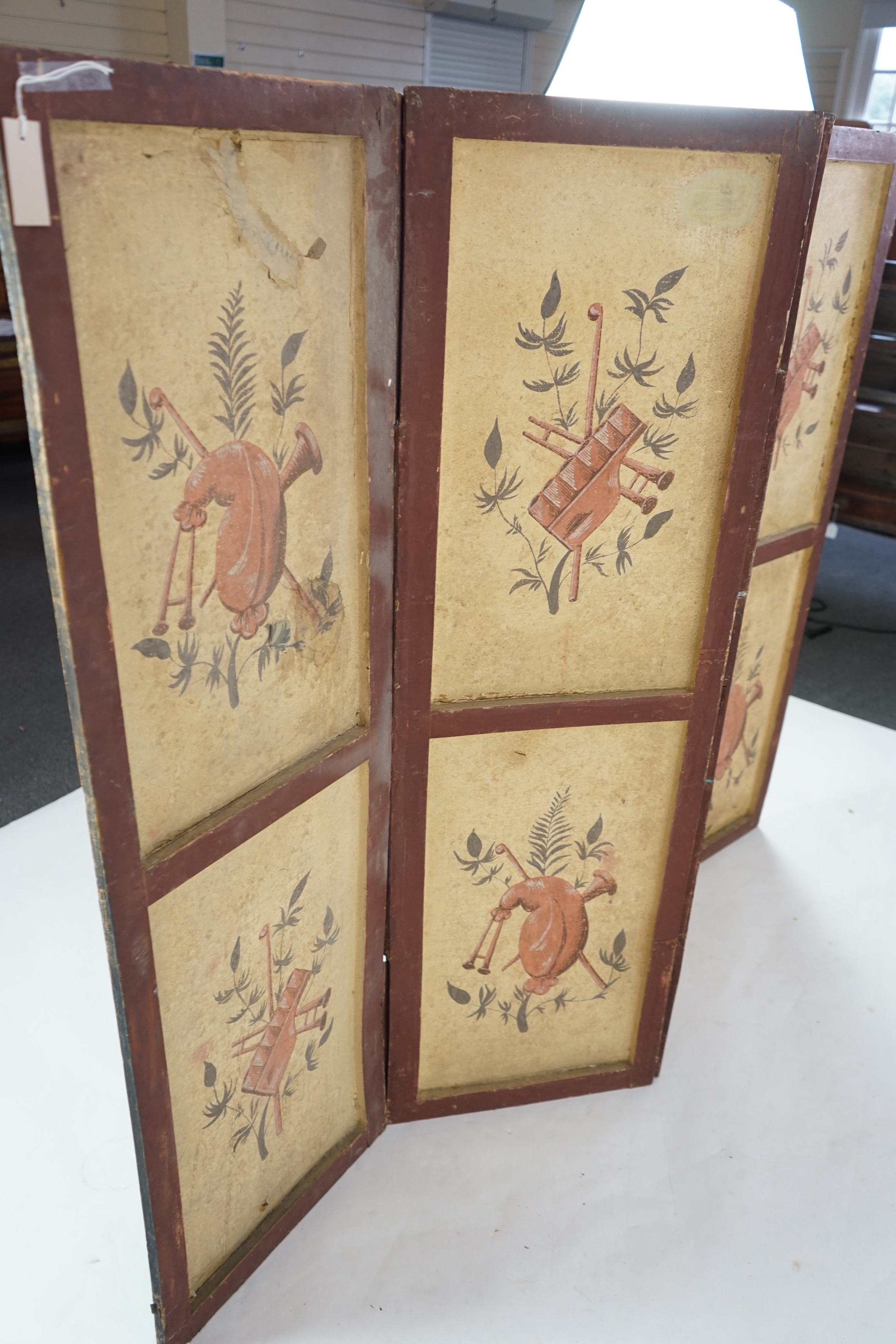 A French Empire four-leaf painted screen, gouache on paper, attributed to Dufour & Leroy, decorated with figures in the grounds of a chateau, the reverse with musical trophies, 47cm wide, 150cm high. Condition - a variet